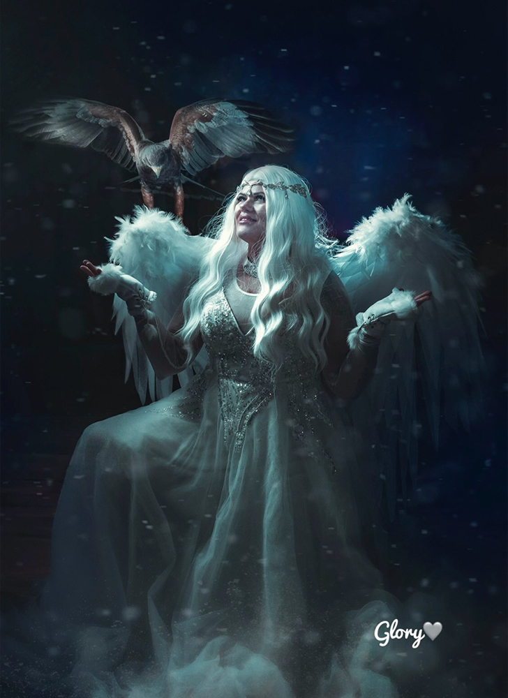 young angel woman wearing large white wings